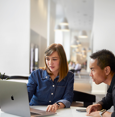 Apple Cork Support and Service team member talking with a coworker.