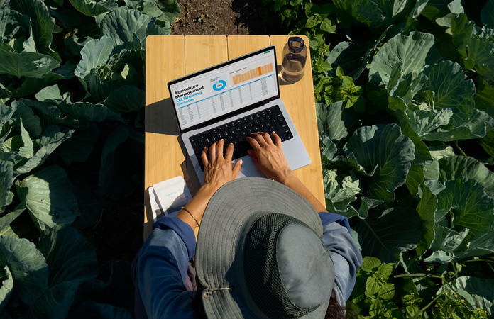 A person uses MacBook Pro with nano-texture display option outside, demonstrating the reduction in glare